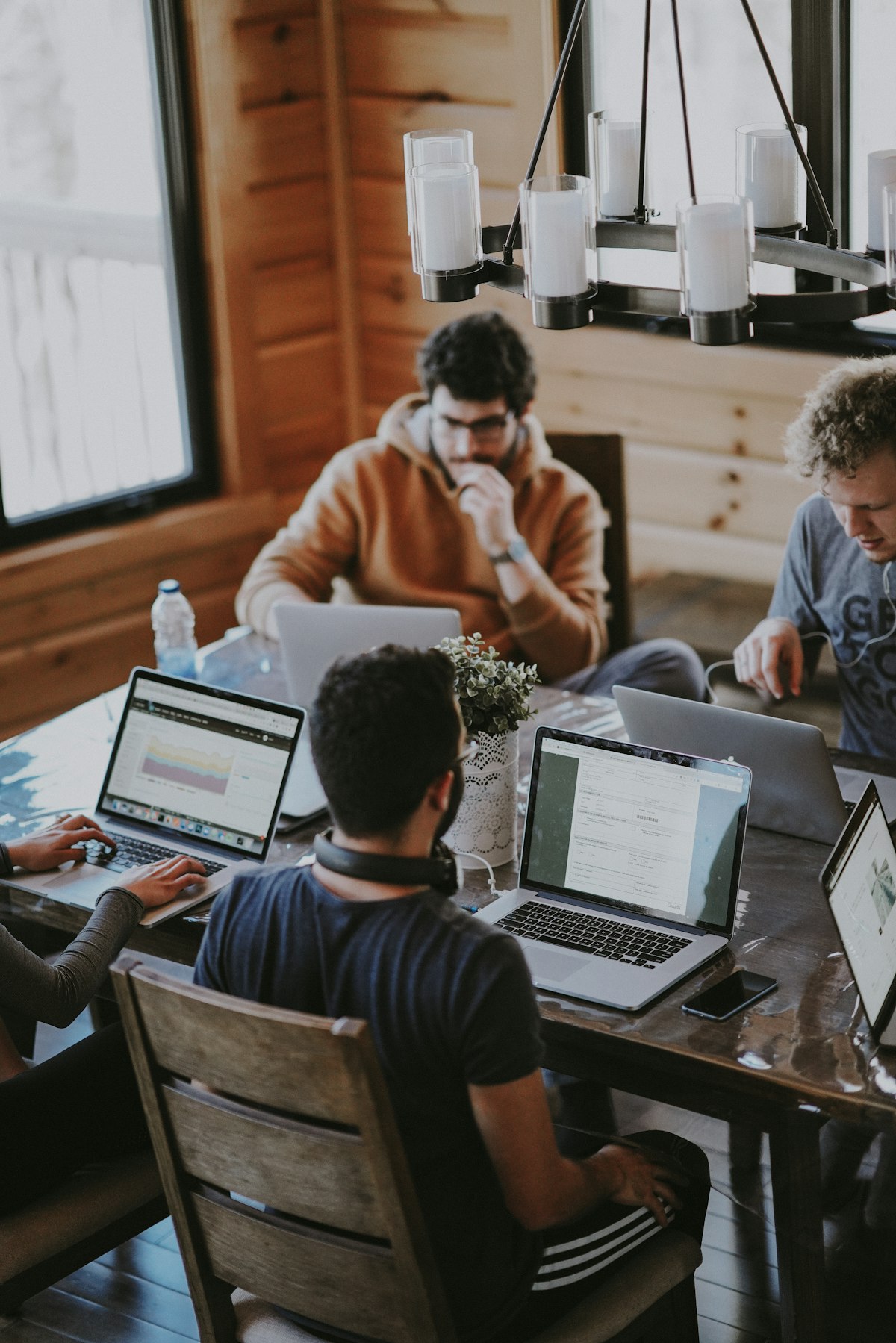 Independent professionals working at laptops in a shared space