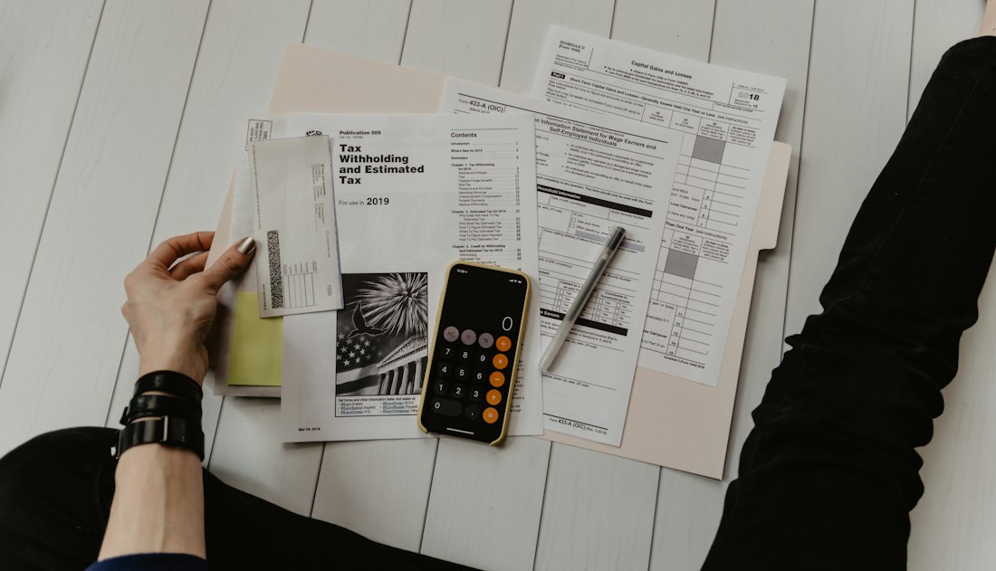Invoices, receipts and a calculator on a desk